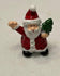 Miniature Santa Figurine Holding Christmas Tree