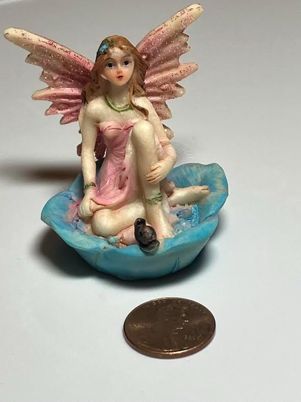 Miniature Pink Wing Fairy Sitting on a Blue Flower